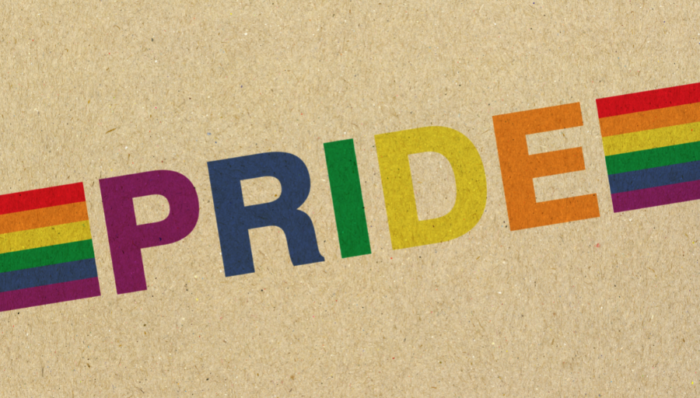 colourful pride text on brown background